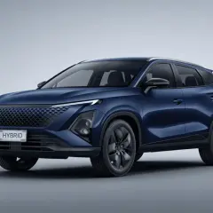 Chery Omoda 5 w kolorze granatowym, z napisem HYBRID na tablicy rejestracyjnej, prezentuje nowoczesny design SUV-a.