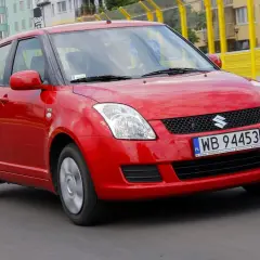 Czerwony Suzuki Swift 2008 na drodze, z widocznymi tablicami rejestracyjnymi WB 94453.