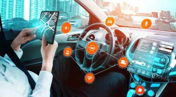Wnętrze samochodu autonomicznego z interfejsem dsc, mapą na tablecie i ikonami technologii.